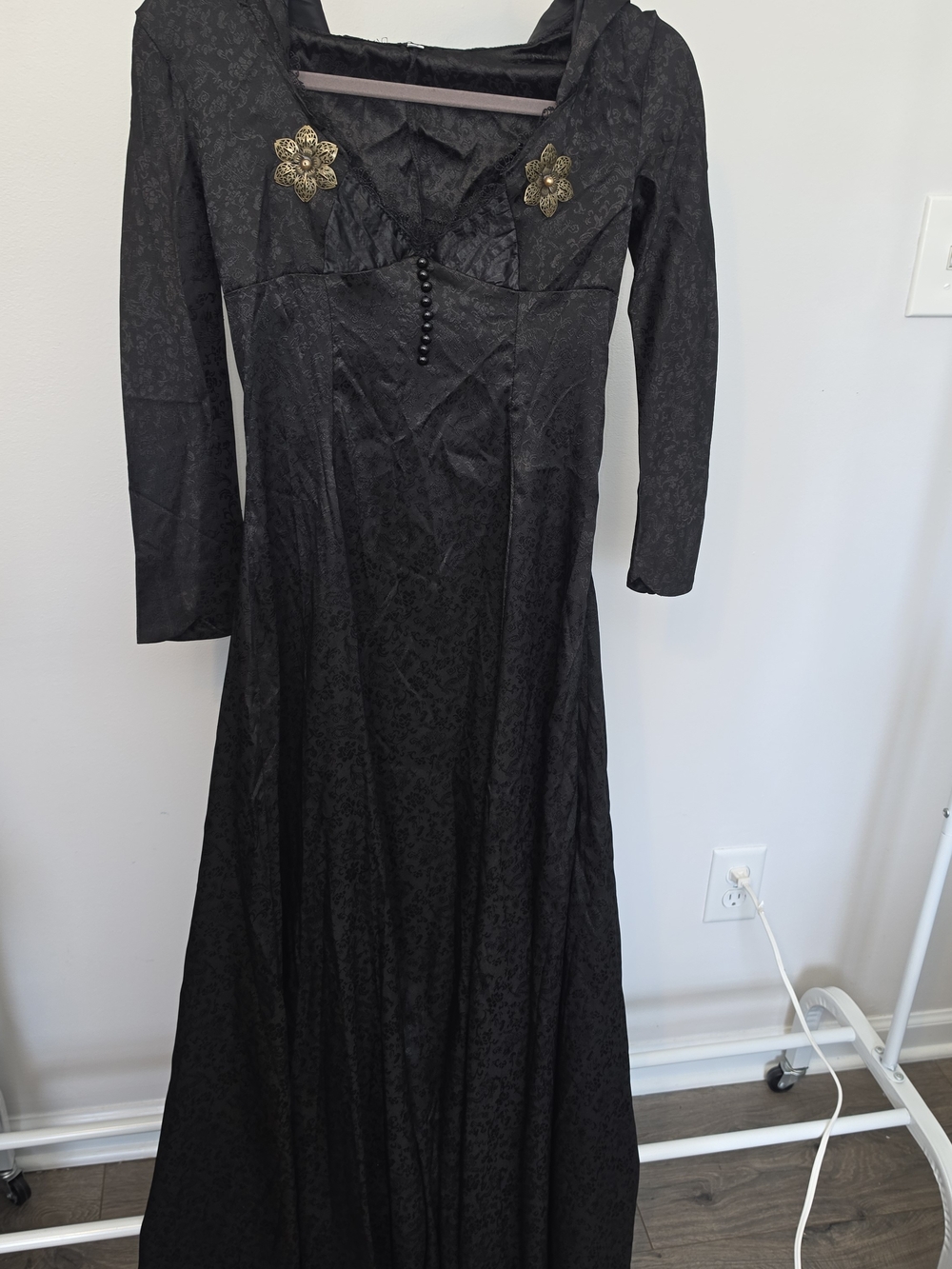 Black lace maxi dress with gold floral appliqués and subtle textured pattern